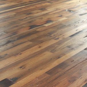 A close up of a wooden floor in a room.