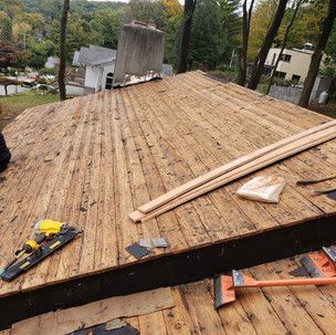 A wooden deck is being built on top of a wooden roof.