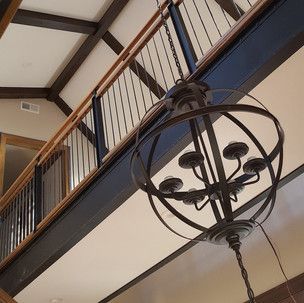 A chandelier is hanging from the ceiling of a house.