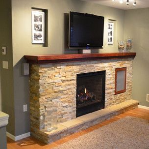 A living room with a fireplace and a flat screen tv