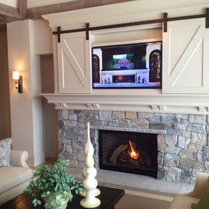 A living room with a fireplace and a flat screen tv above it.