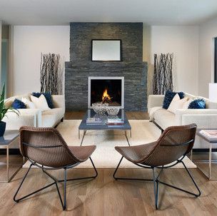 A living room with a fireplace and two chairs