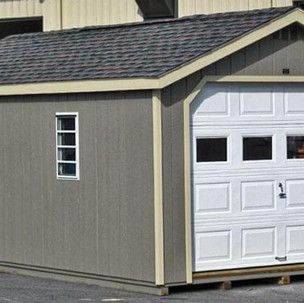 A small shed with a garage door and a window.