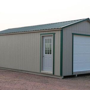 A small shed with a garage door and a window.
