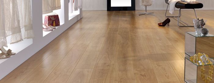 A store with a wooden floor and a display of shoes.
