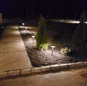 A driveway with a lot of lights on it at night.