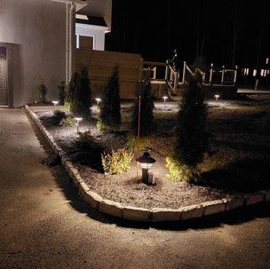 A driveway with a lot of lights on it at night.