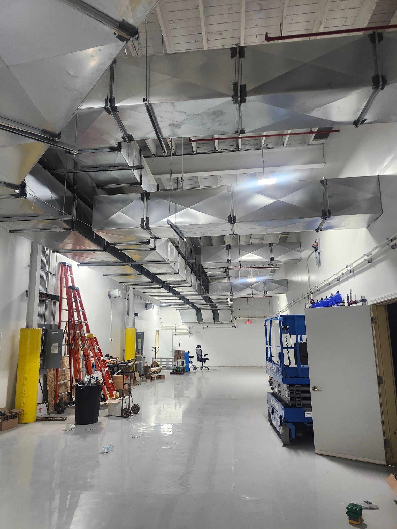 A large room with a lot of pipes hanging from the ceiling