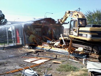 Crane demolishing the commercial building — Building Demolition in Yakima, WA