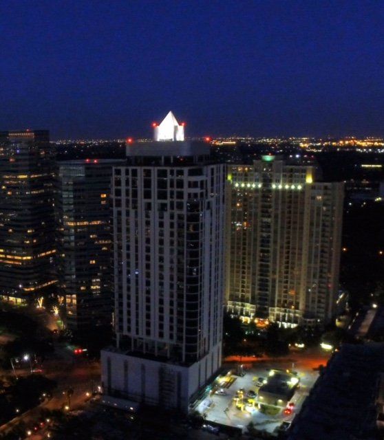 A very tall building with a house on top of it