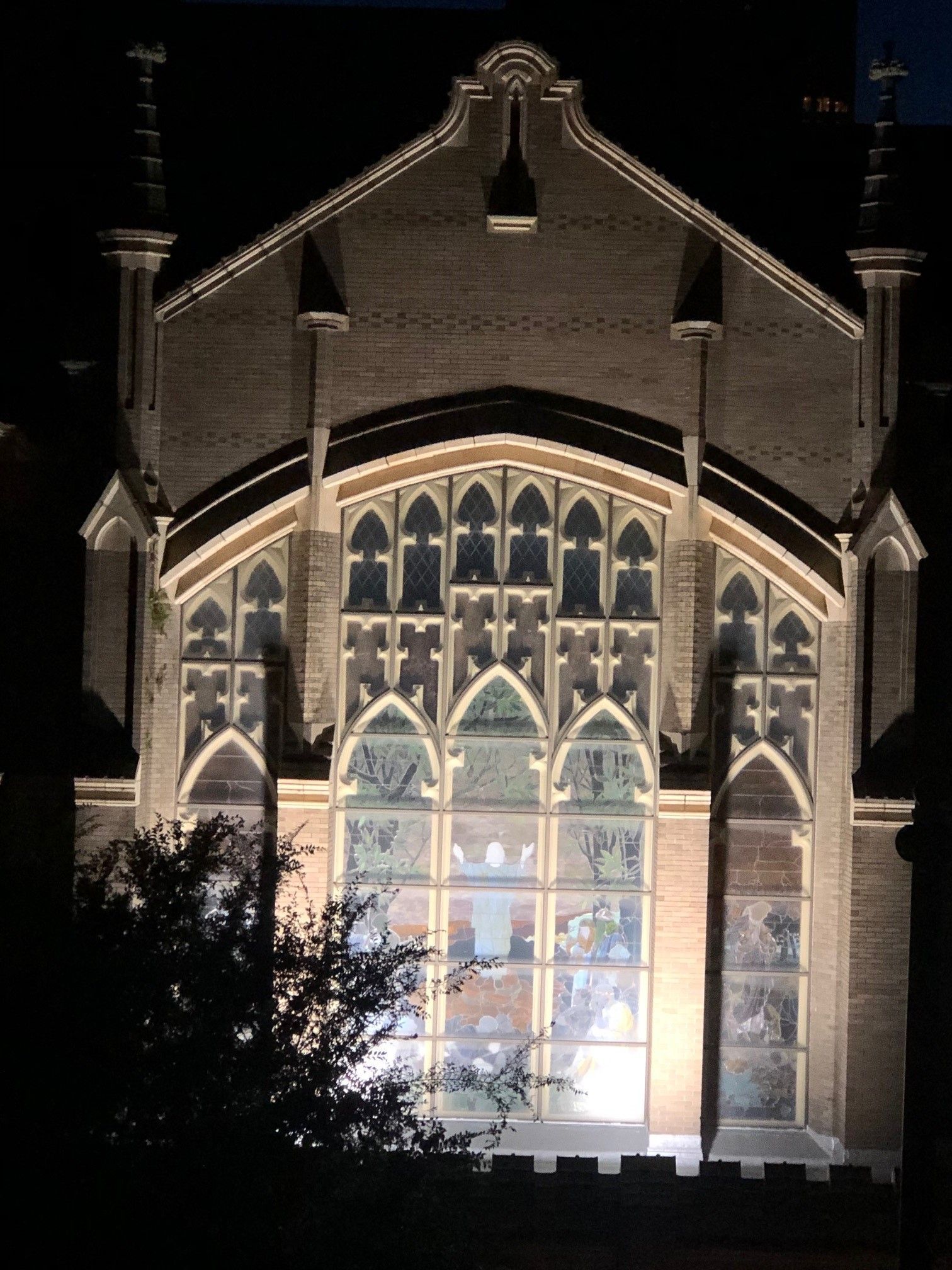 A large building with a lot of windows is lit up at night