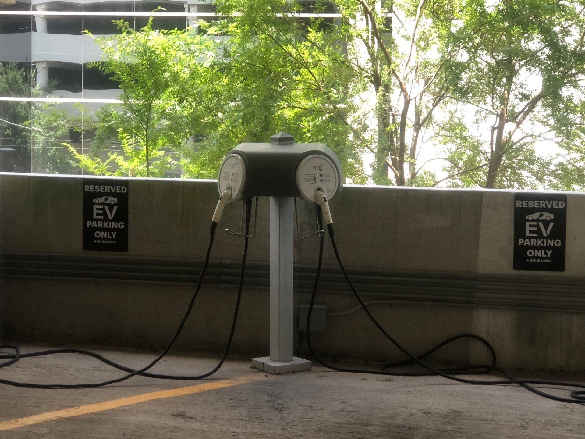 Two electric vehicle charging stations in a parking garage