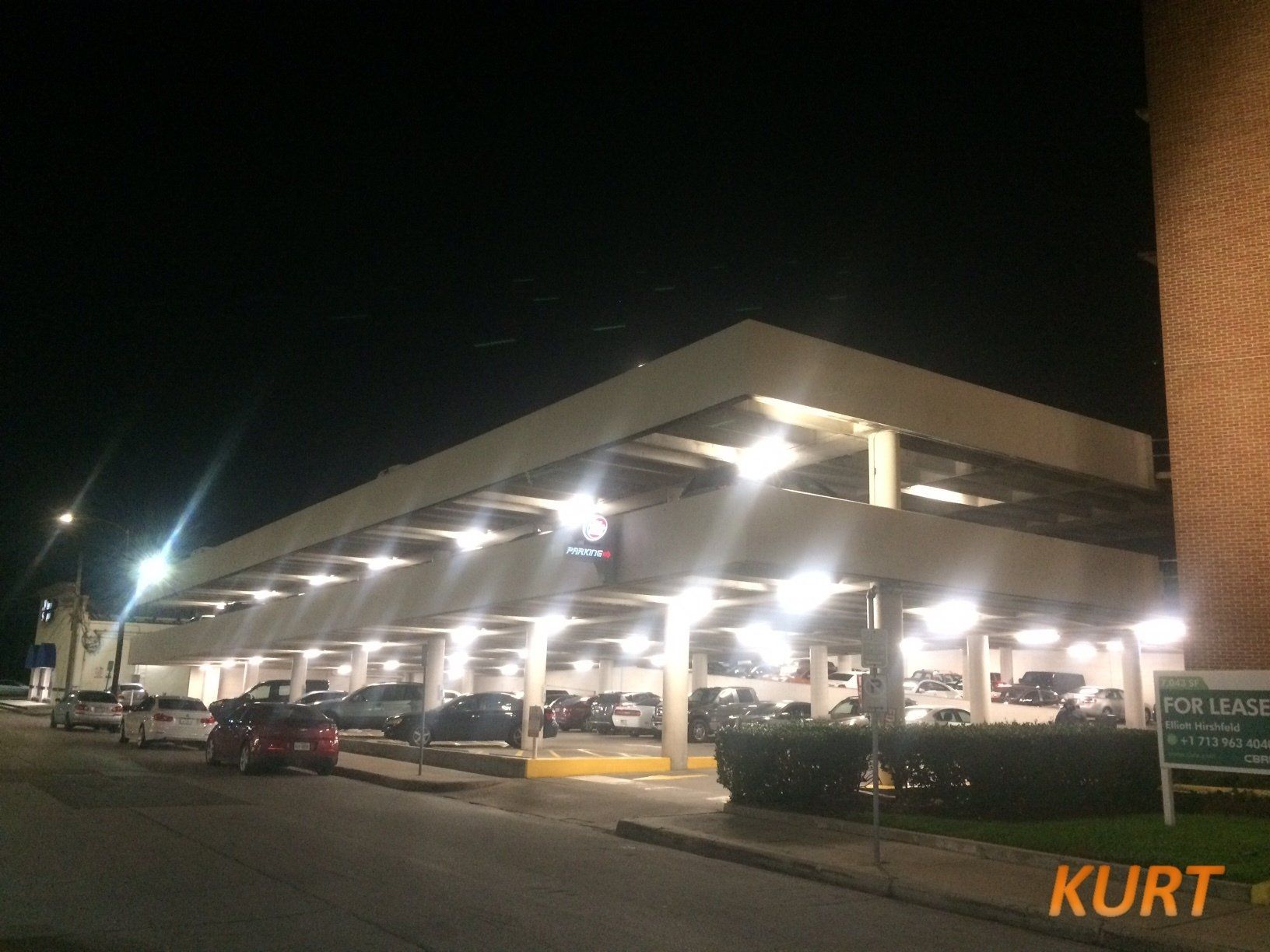 A parking garage with a sign that says kurt on it
