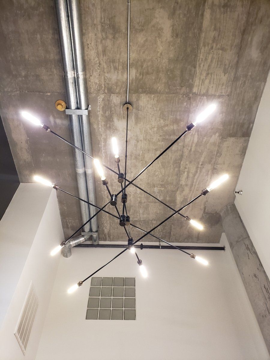 A chandelier is hanging from the ceiling of a room.