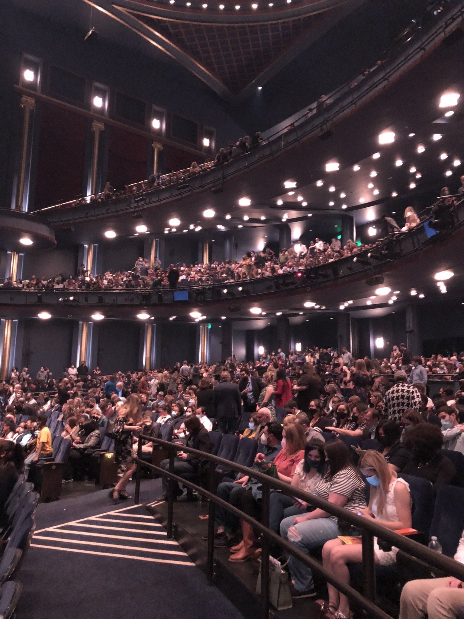 A large auditorium with a lot of people sitting in it