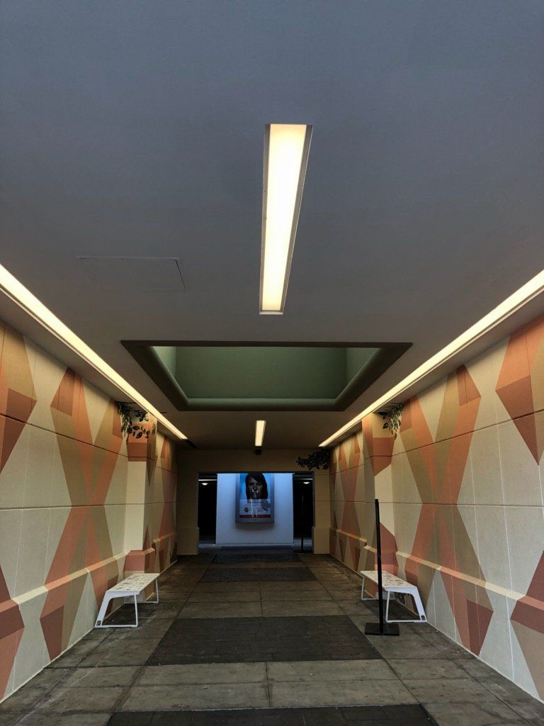 A long hallway with a light on the ceiling