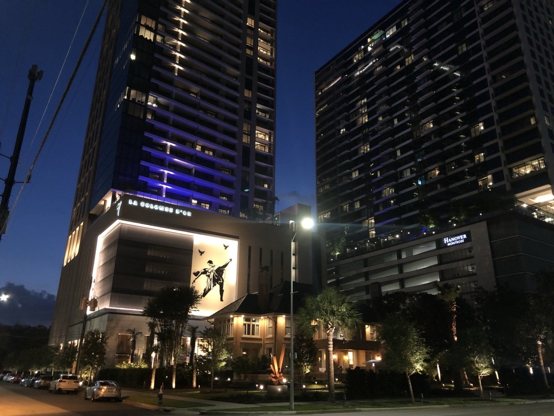 A large building with a blue light on it is lit up at night