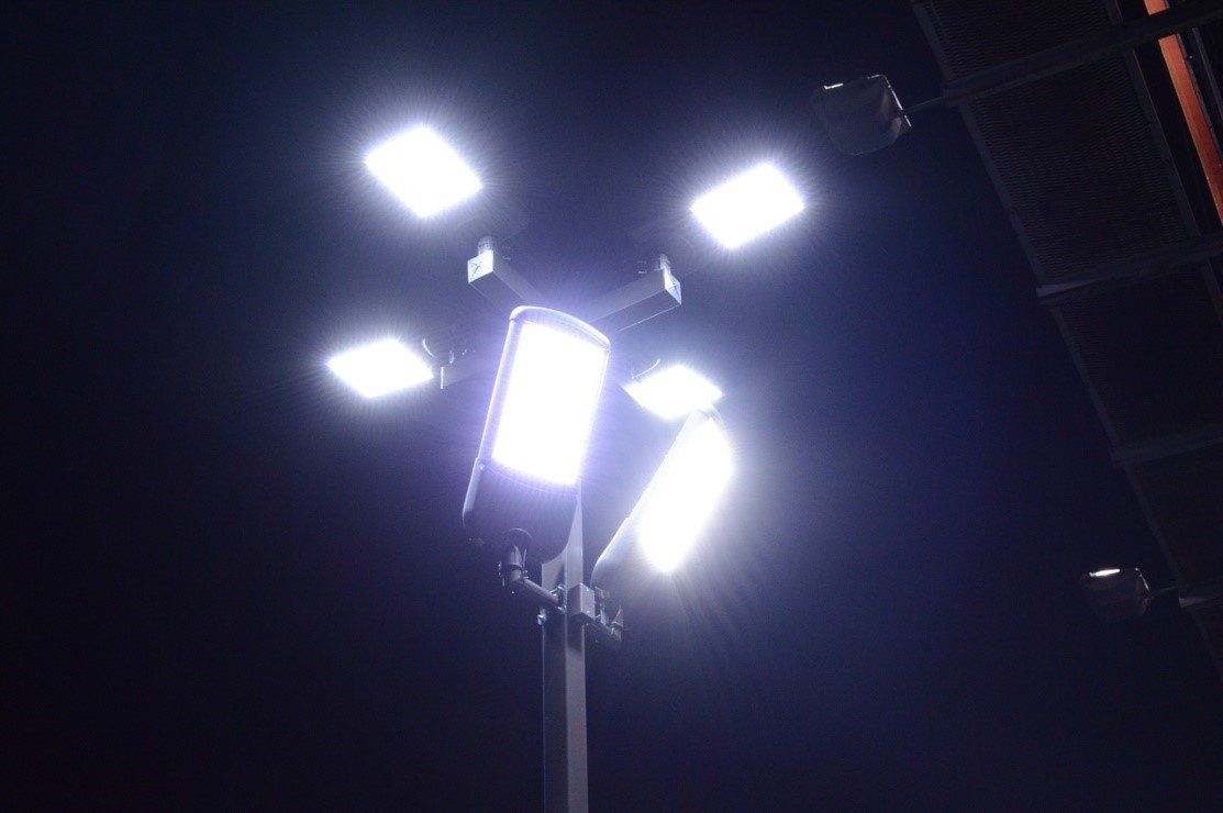 A street light is lit up at night in the dark.