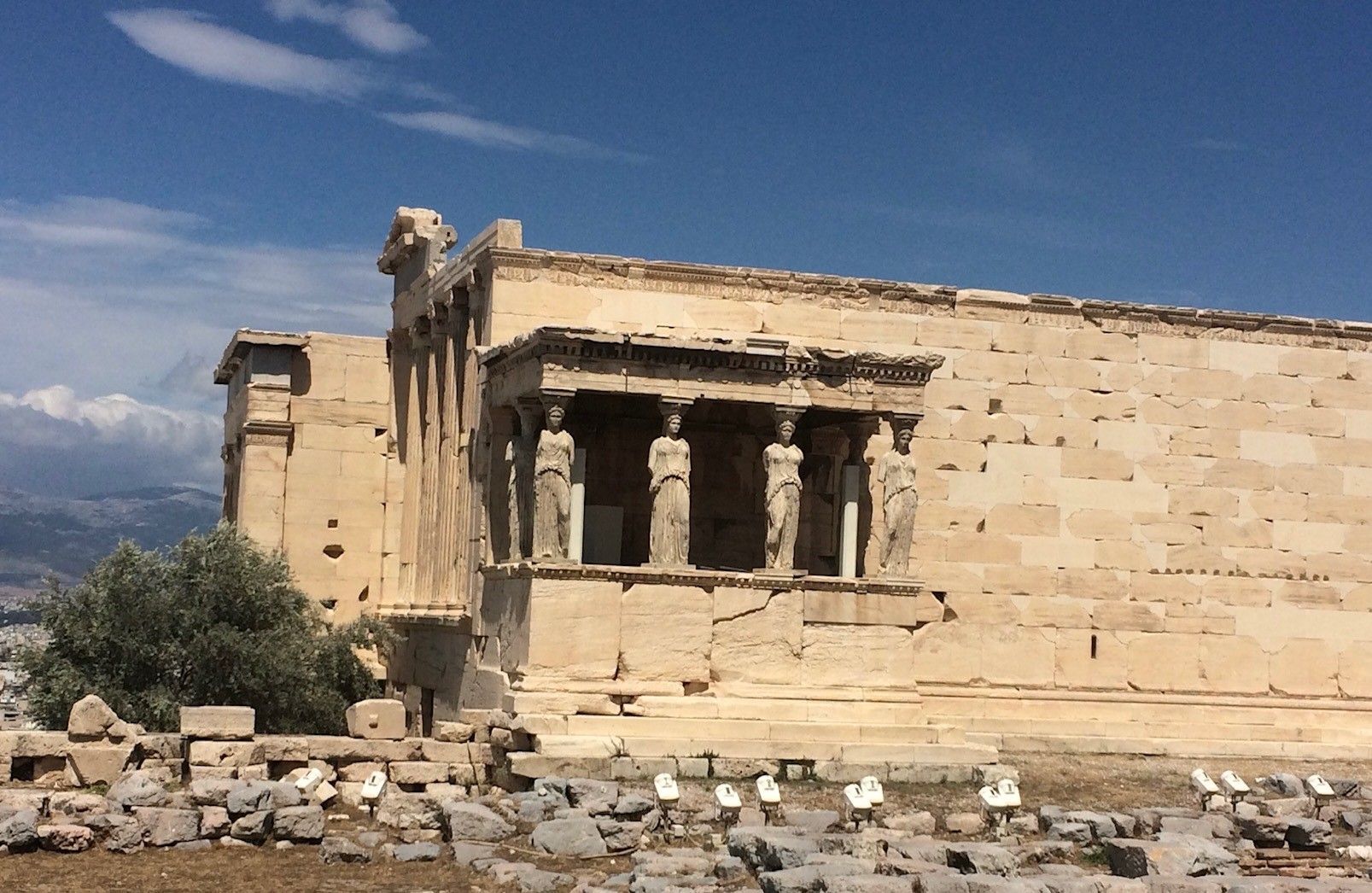 A very old building with columns and statues on it