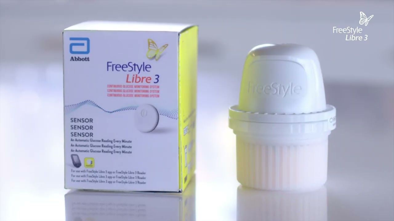 A freestyle libre 3 device is sitting next to a box on a table.