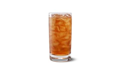 A tall glass filled with iced tea on a white background.