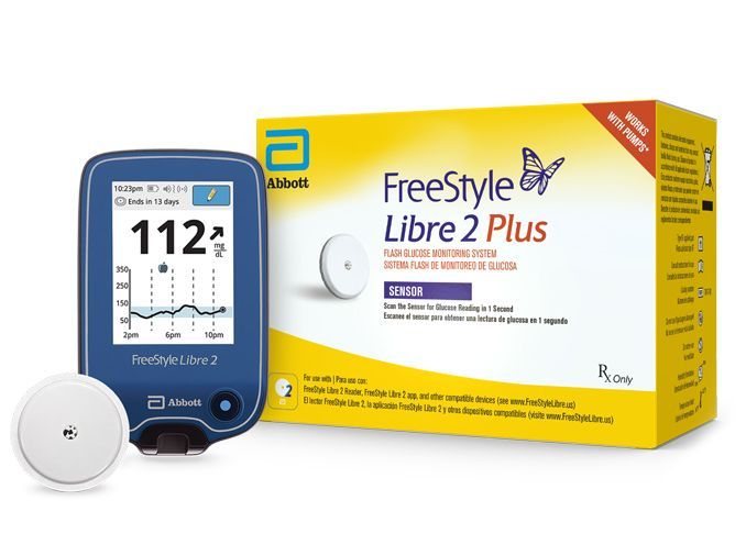 A freestyle libre 2 plus device is sitting next to a box.