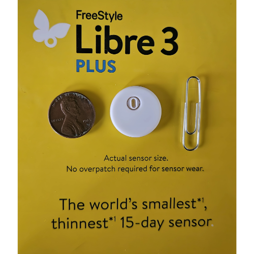A freestyle libre 3 device is sitting next to a box on a table.
