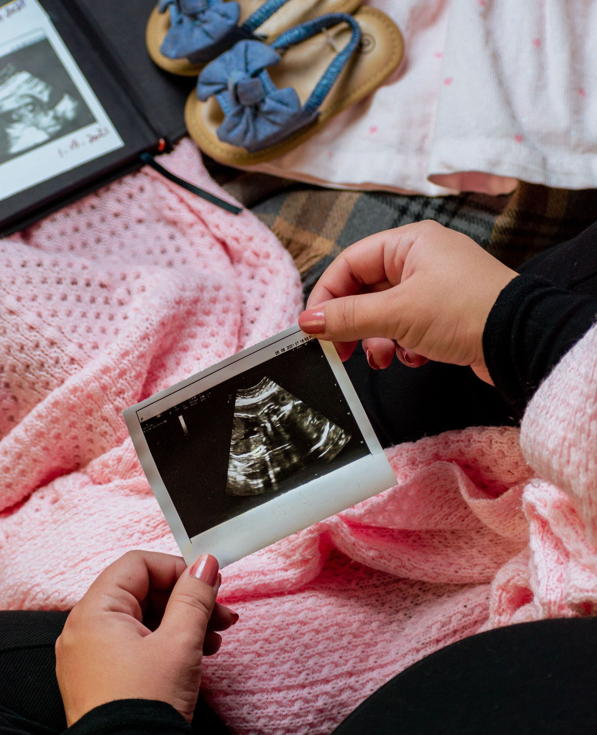 woman looking at ultrasound of baby