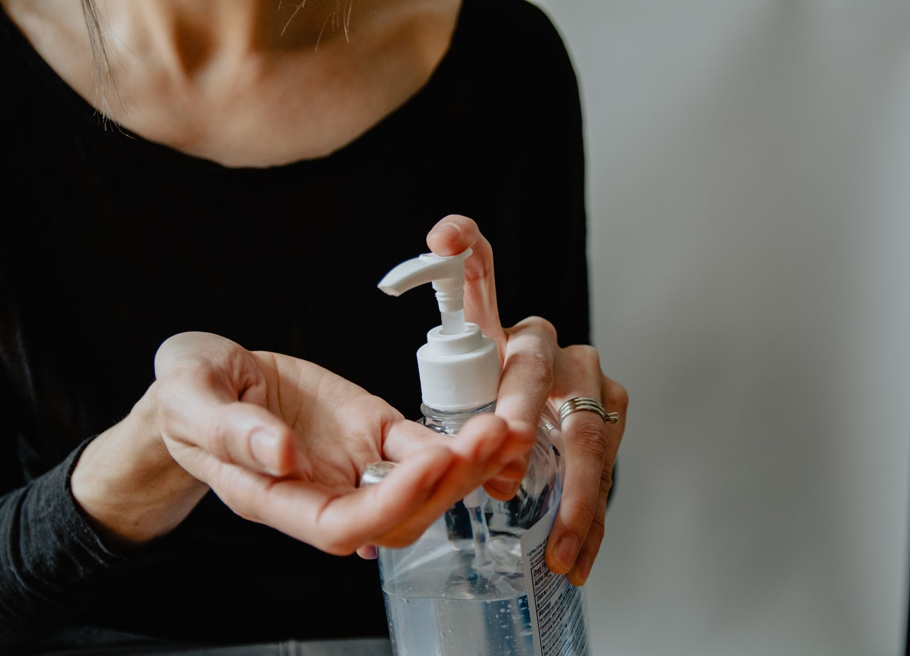 woman using hand sanitizer