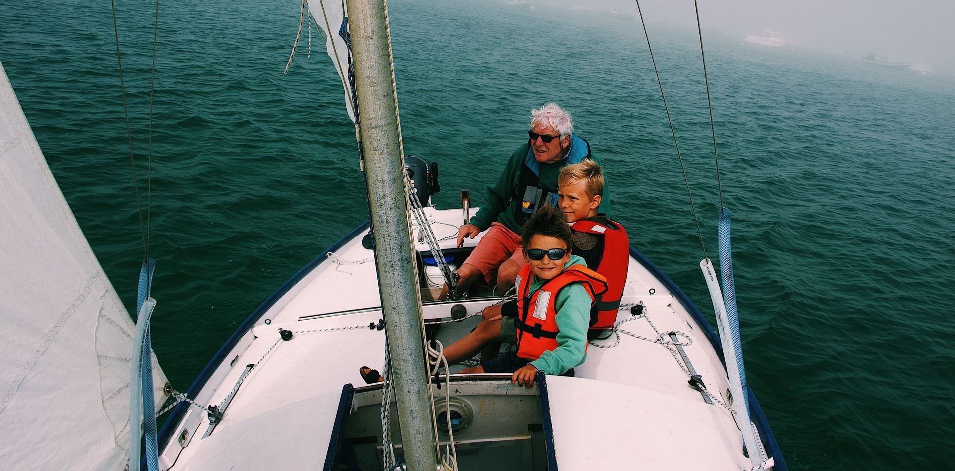 man and 2 kids sailing
