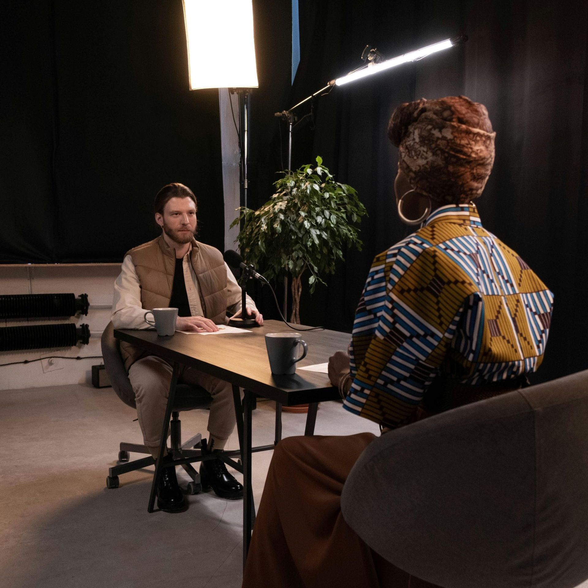 A man and a woman are sitting at a table talking to each other