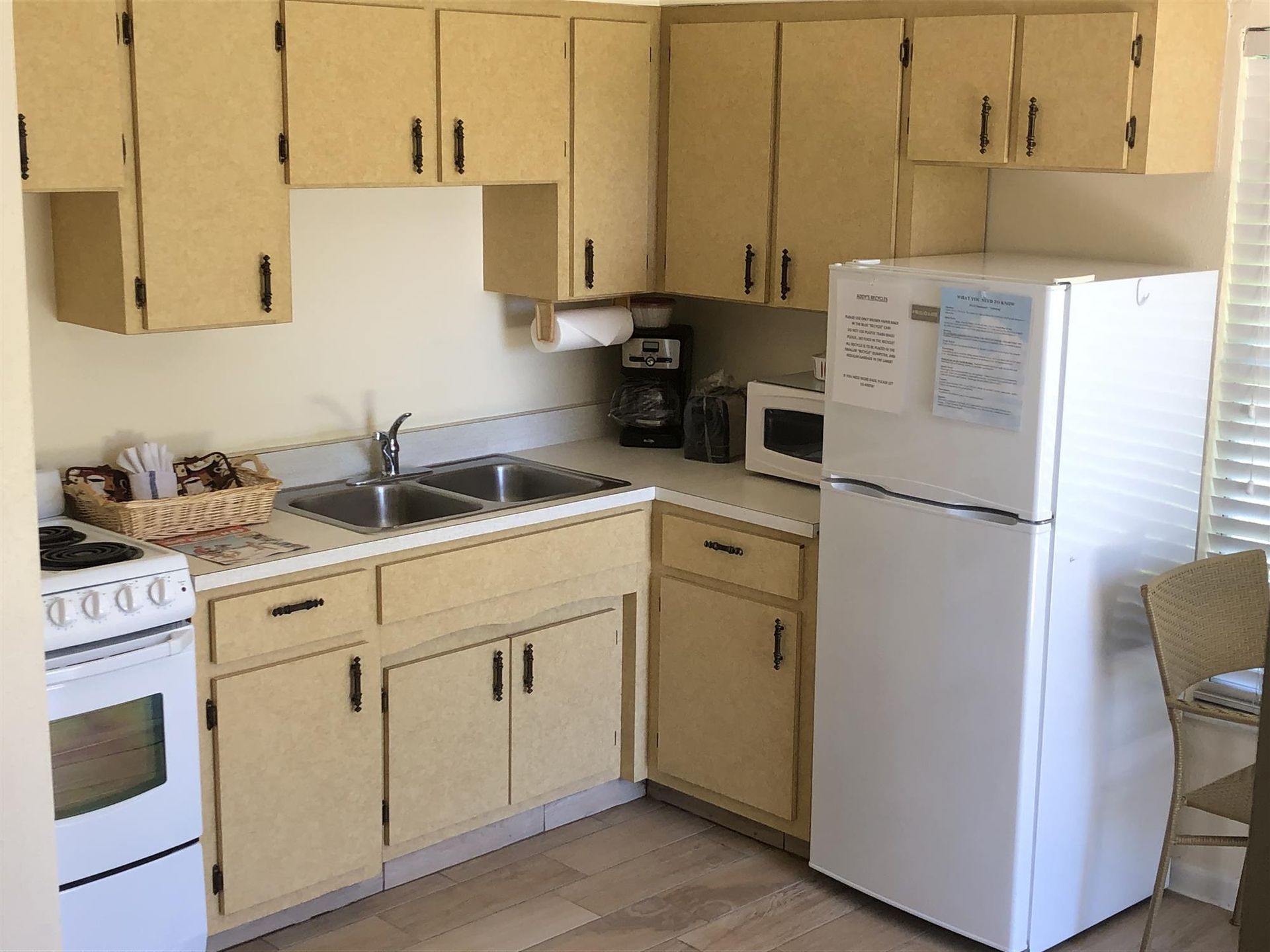 A kitchen with two sinks and a refrigerator that says ' nc ' on it