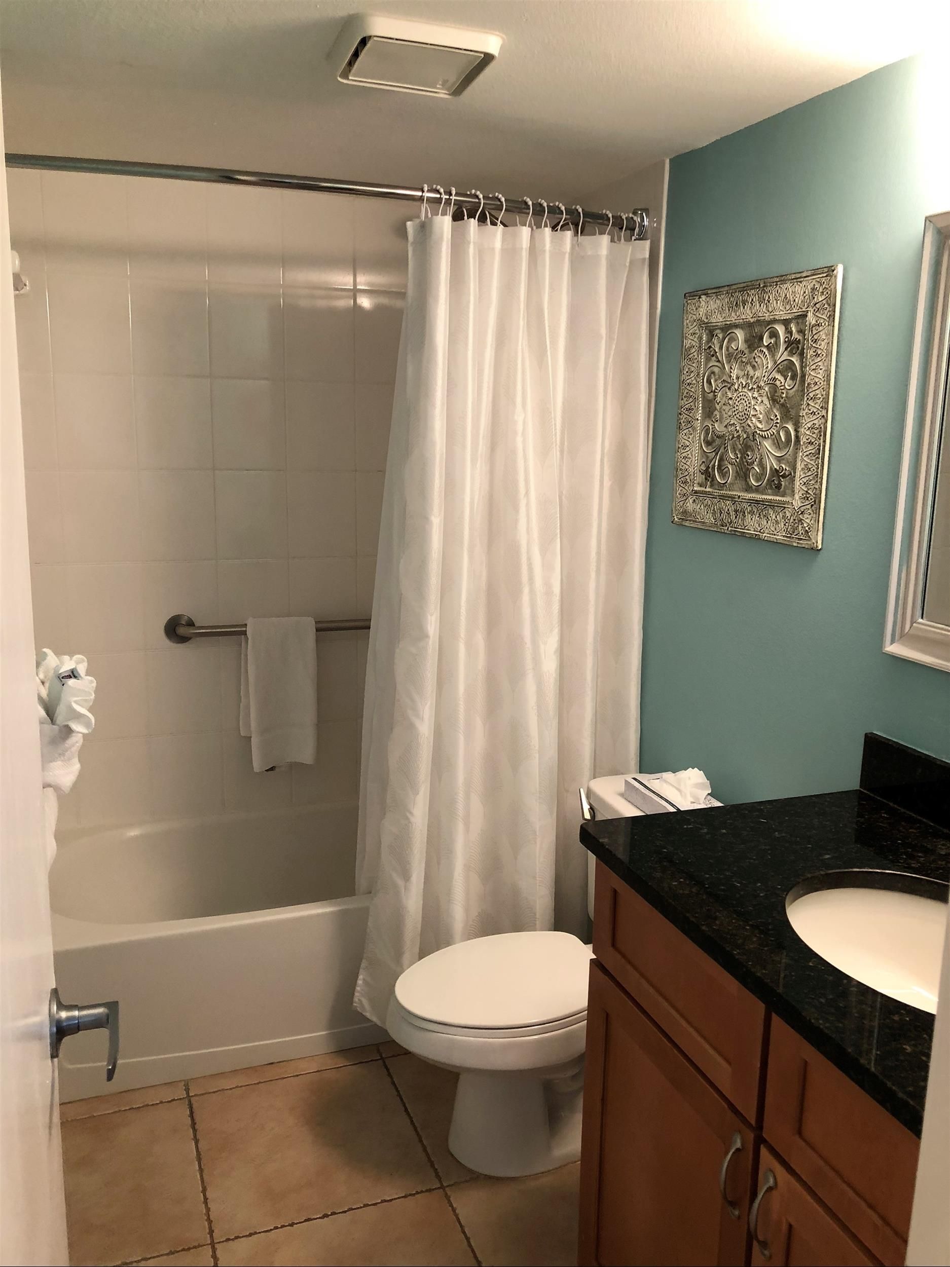 A bathroom with a toilet a sink and a bathtub