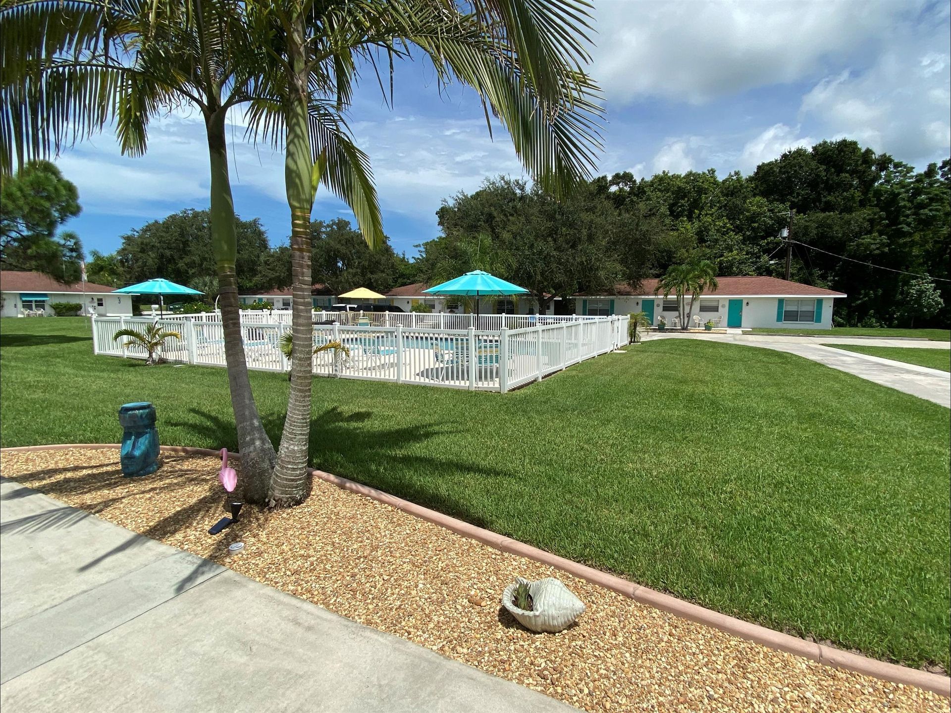 A house with a pool and umbrellas in the backyard