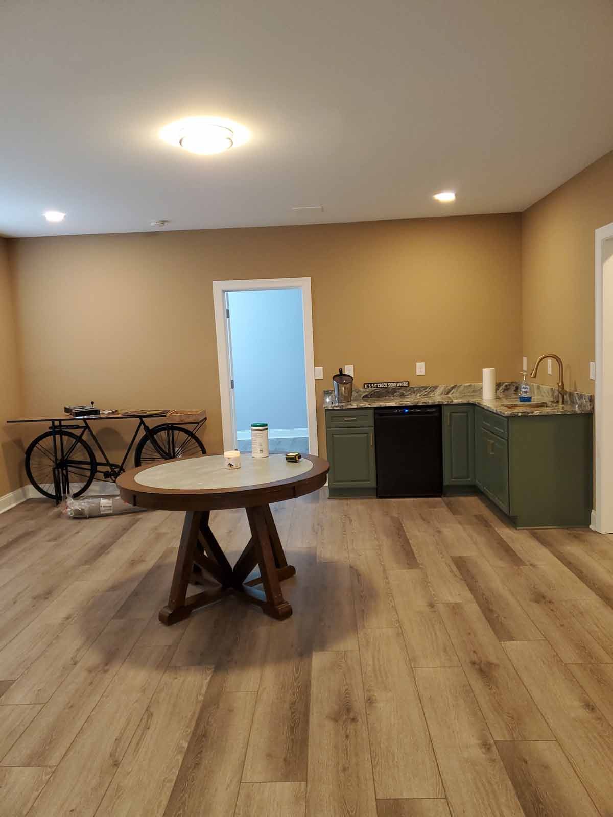 A room with a table and a bicycle in it.