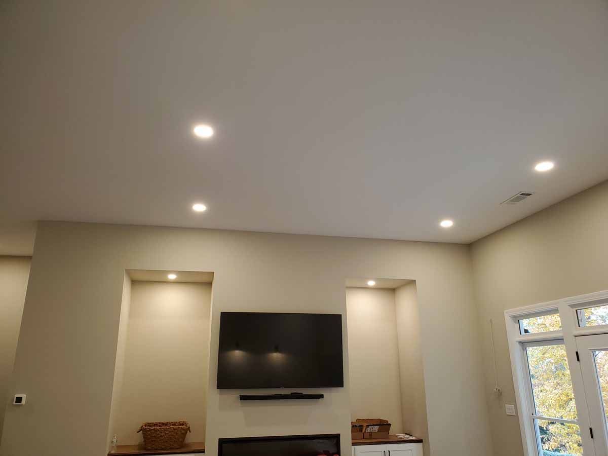 A living room with a flat screen tv and a fireplace.