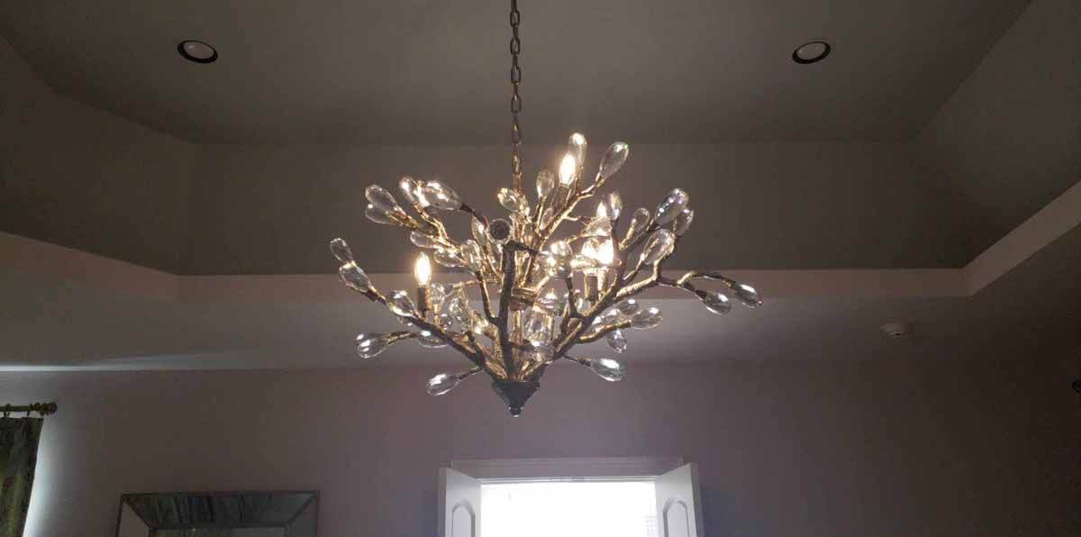 A chandelier is hanging from the ceiling in a room.