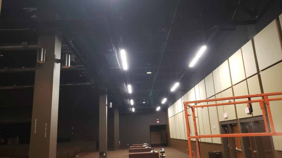 A large empty room with a lot of lights on the ceiling.