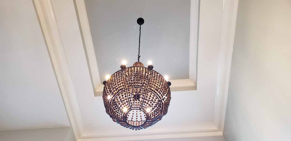 A large chandelier is hanging from the ceiling of a room.