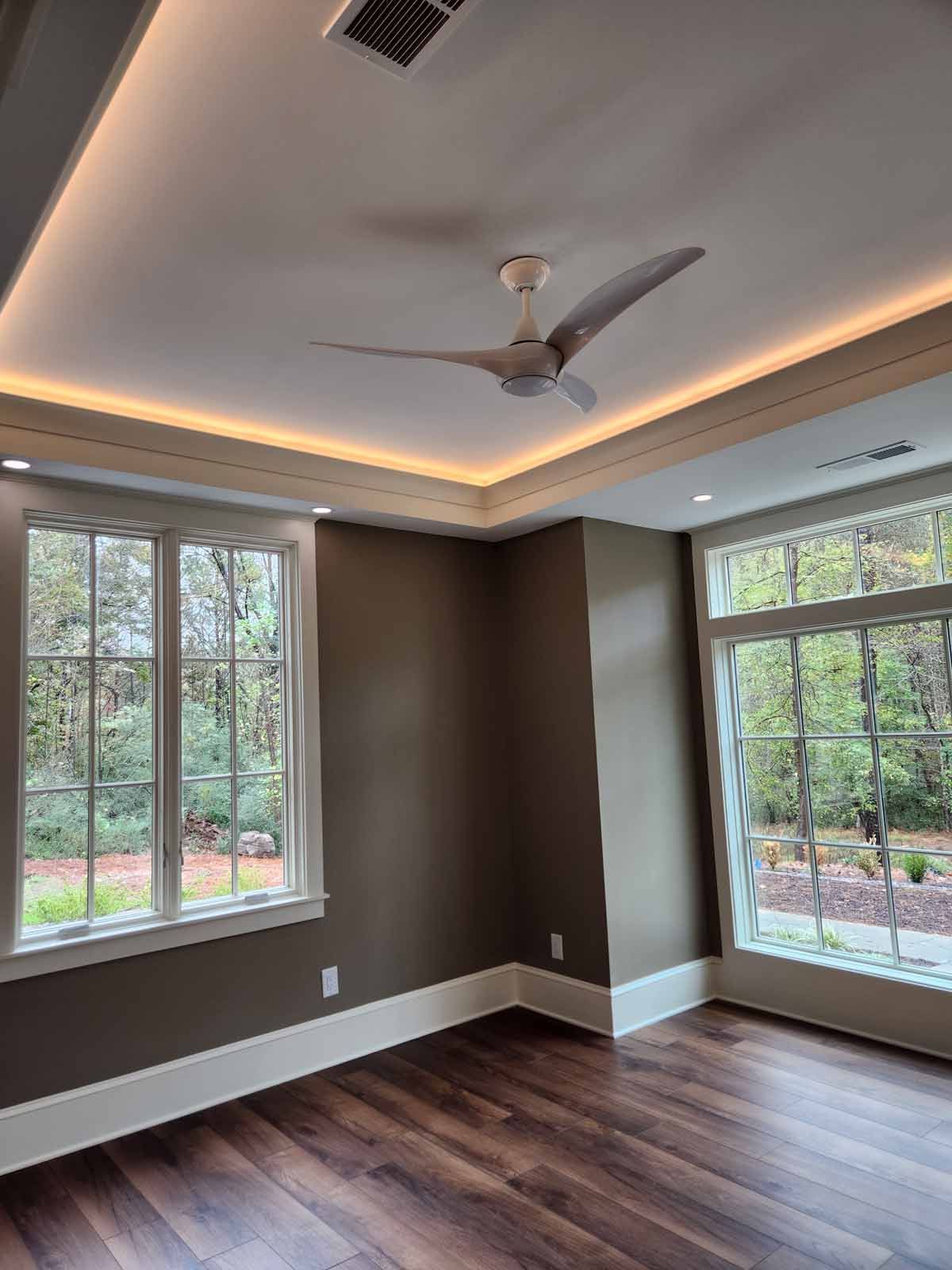 There is a ceiling fan in the corner of the room.