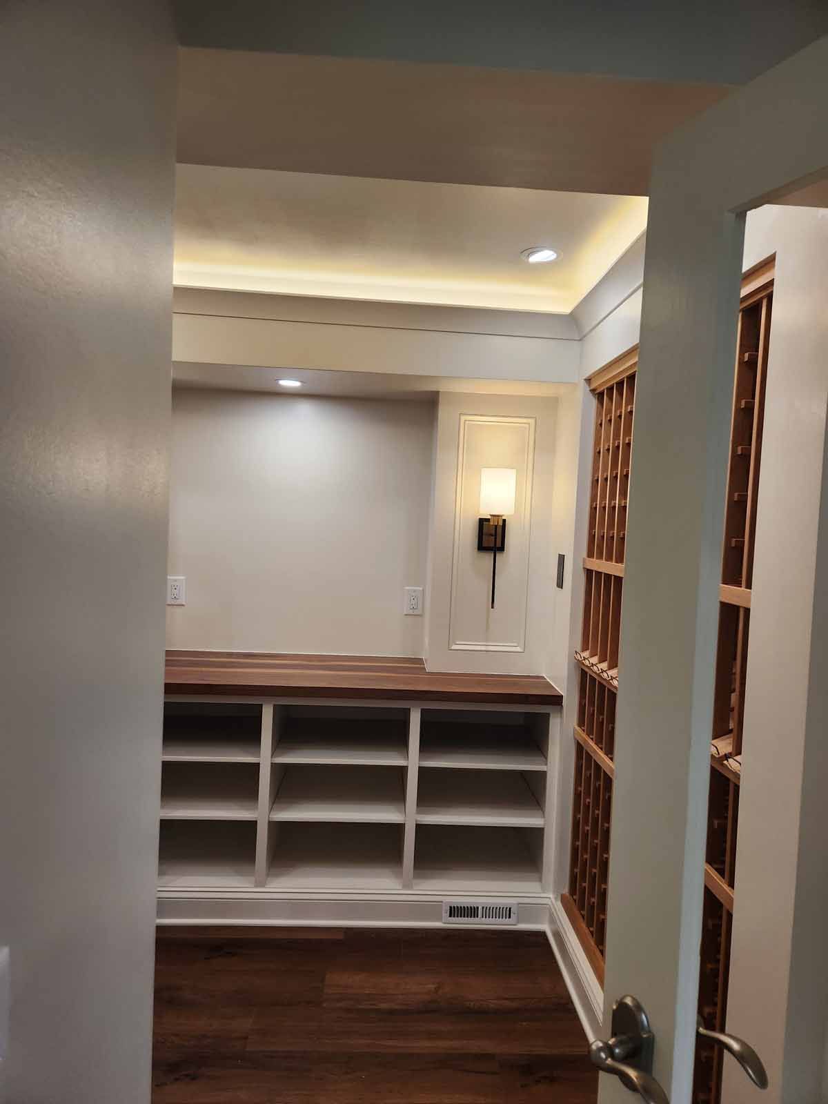 A room with shelves and a light on the wall