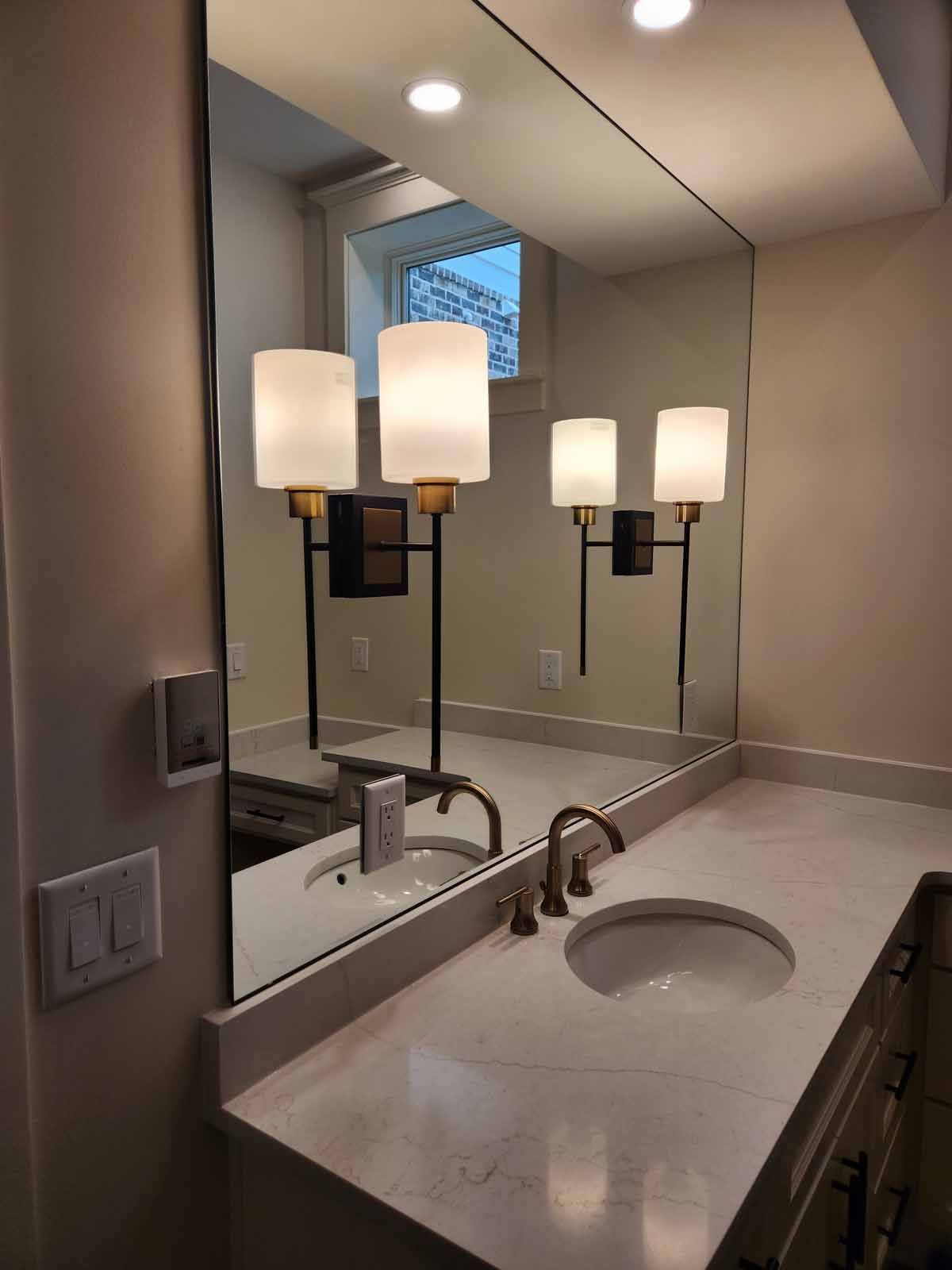 A bathroom with two sinks and a large mirror.
