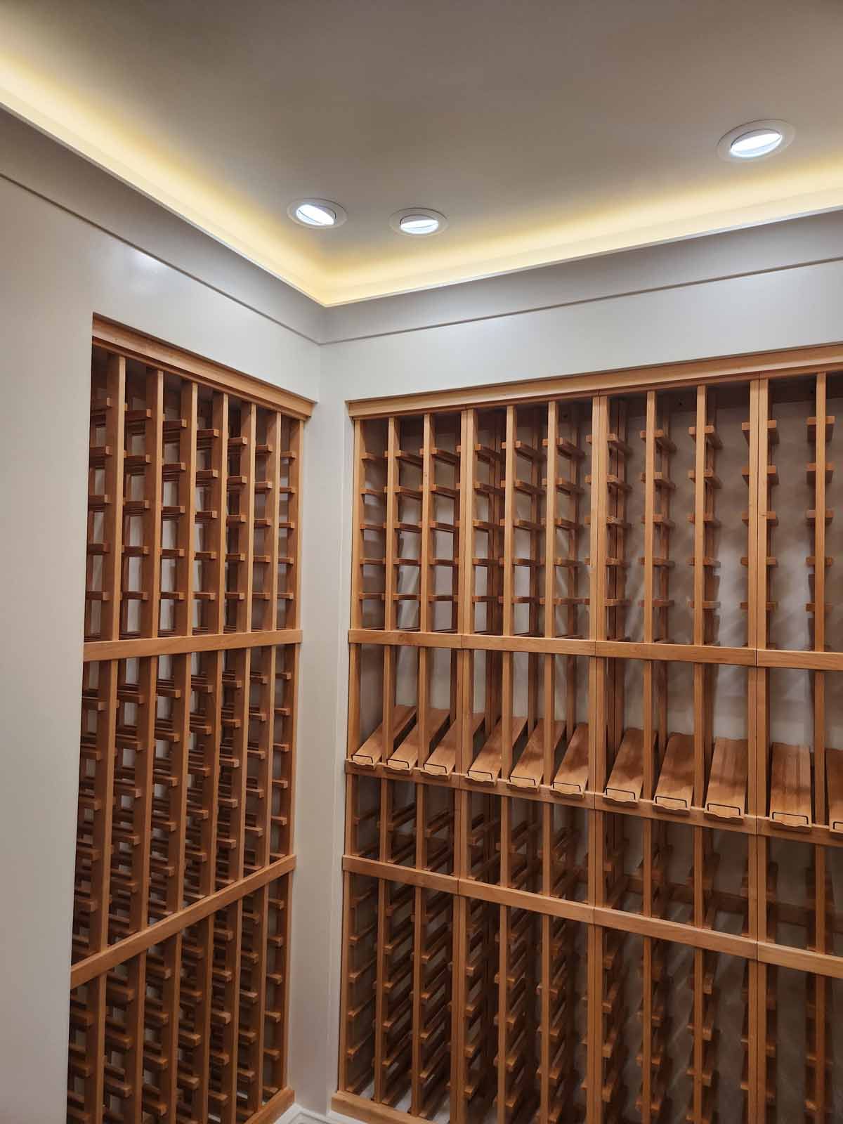 A large wine cellar filled with wooden shelves and bottles.