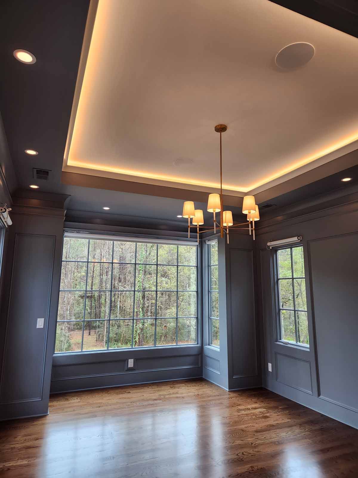 A living room with hardwood floors and a chandelier hanging from the ceiling.