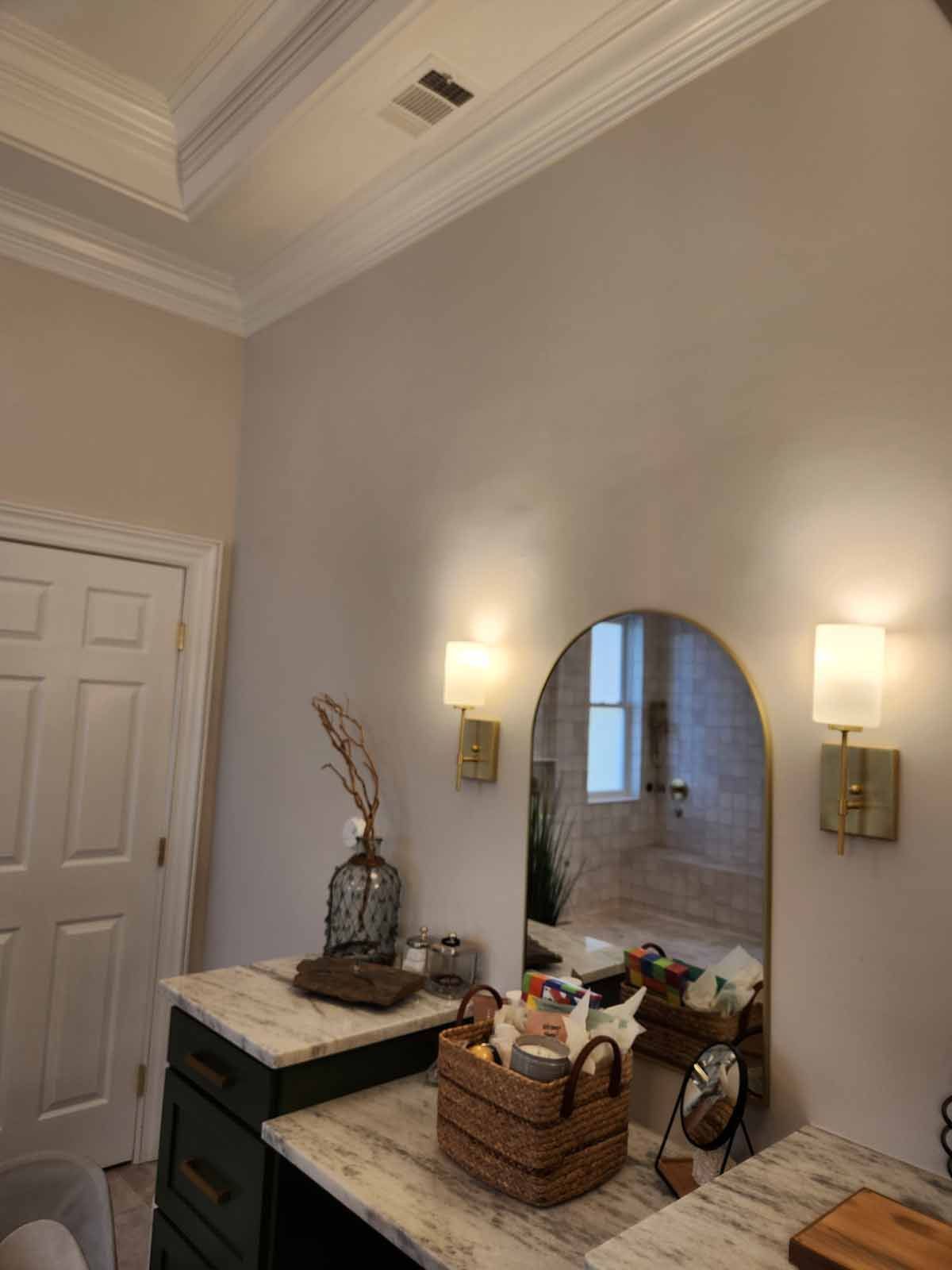 A bathroom with a vanity and a mirror