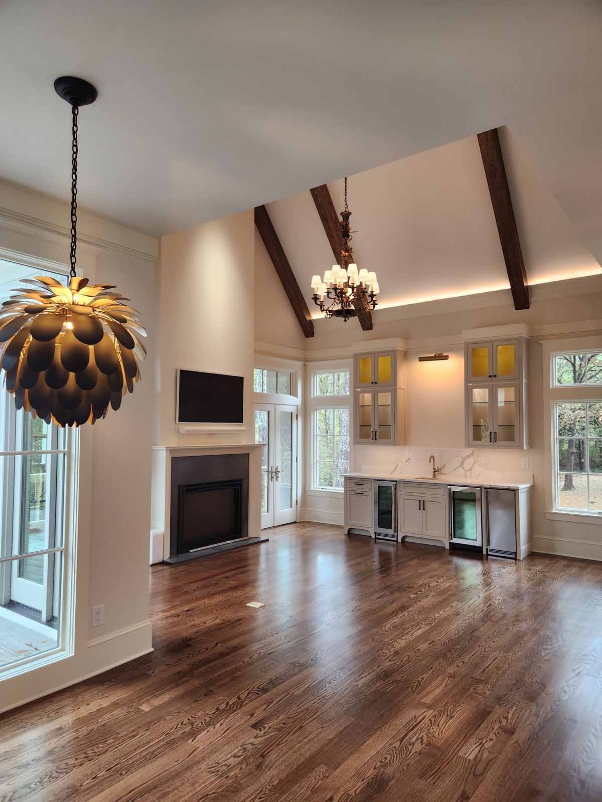 A living room with a fireplace and a chandelier hanging from the ceiling
