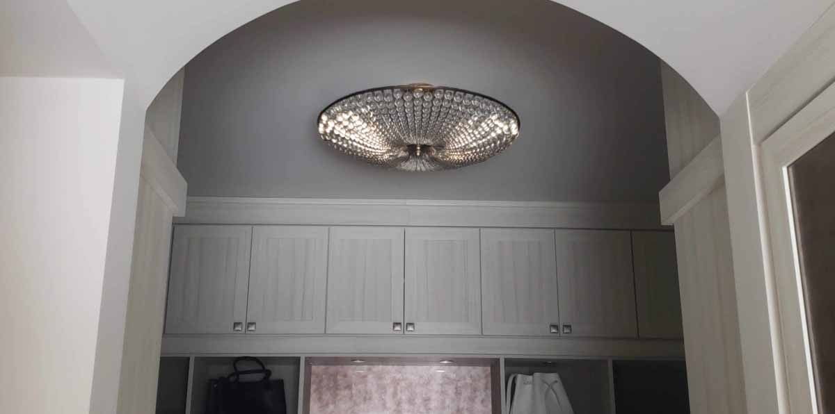 A hallway with a chandelier hanging from the ceiling.