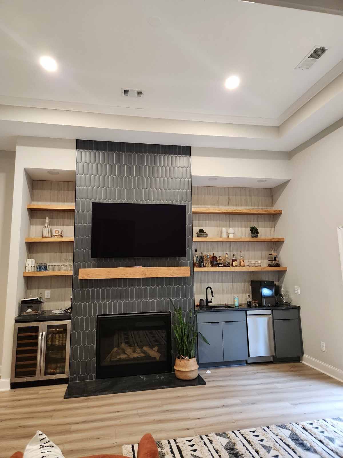A living room with a fireplace and a flat screen tv.