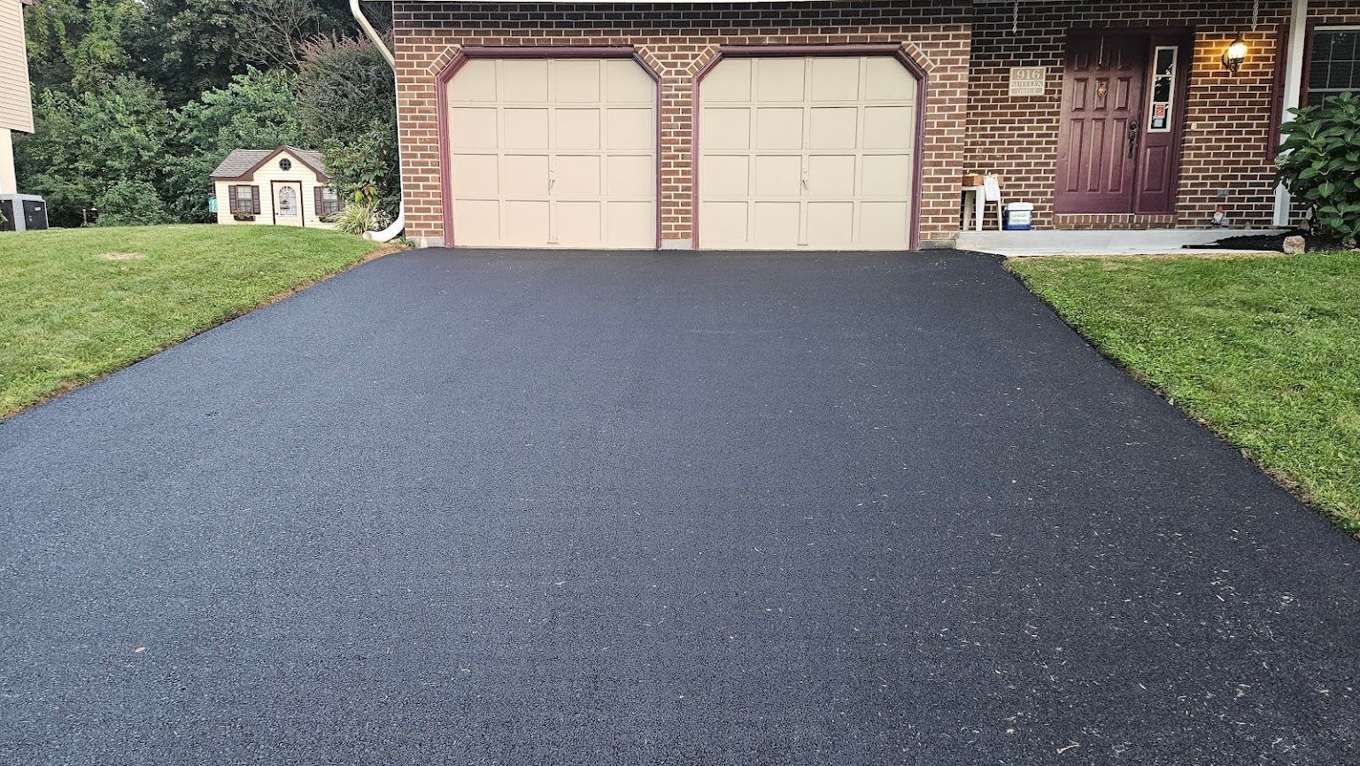 A Driveway Leading to a House with Two Garage Doors — Kutztown, PA — B Young Paving