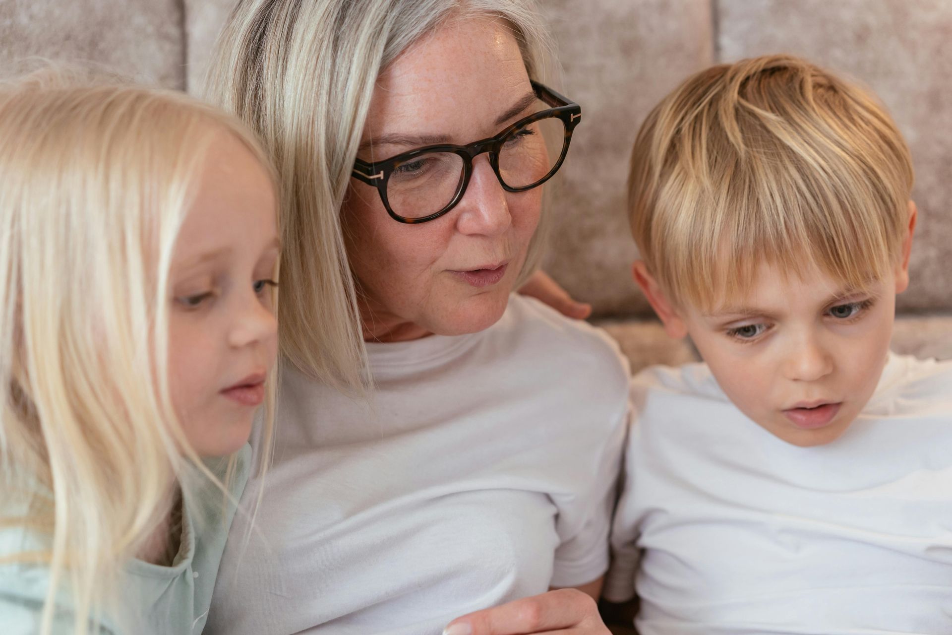 Mother with her daughter and son looking at something